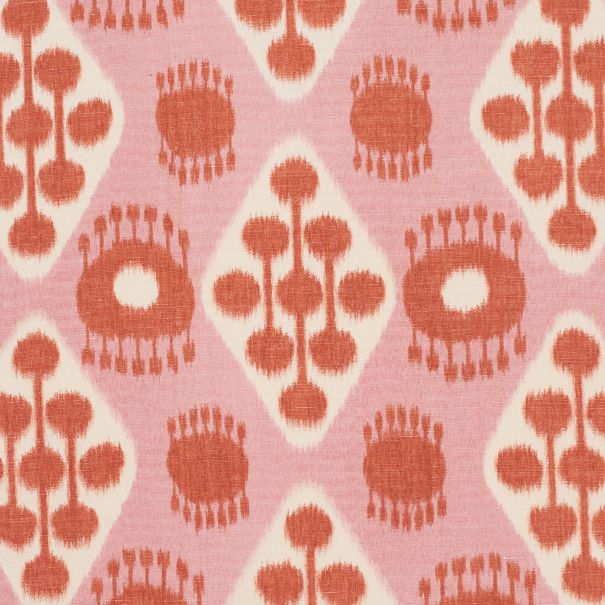Patterned Ikat fabric in pink and tangerine with diamond panels, sunburst circles and bead-stem motifs; vintage geometric textile