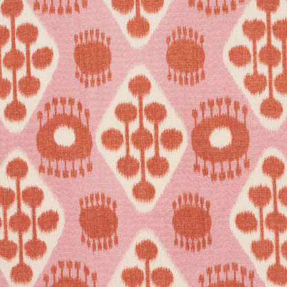 Patterned Ikat fabric in pink and tangerine with diamond panels, sunburst circles and bead-stem motifs; vintage geometric textile