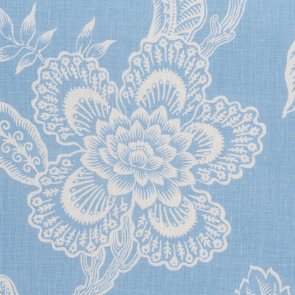 Blue fabric with white intricate floral pattern, featuring a large central bloom and leafy vines.
