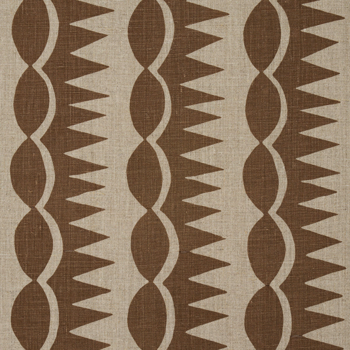 Brown and beige woven fabric with vertical columns of oval shapes and triangular teeth in a retro geometric pattern.