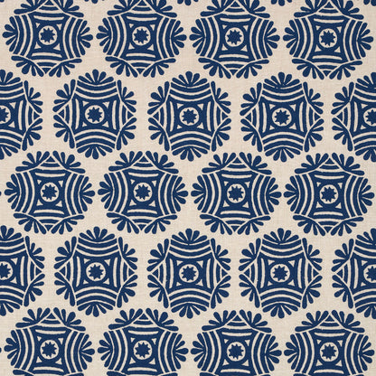 Navy blue circular geometric medallion pattern on natural fabric, with repeating star-like rosettes and radiating segments.
