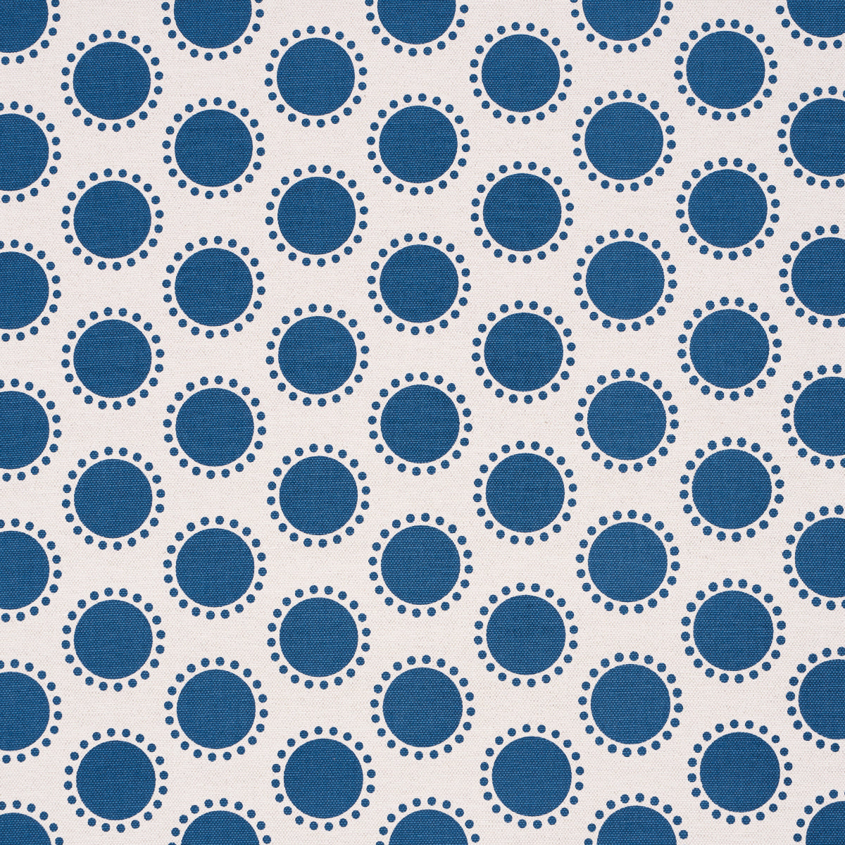 Beige fabric with repeating navy blue circles outlined by dotted rings; retro geometric polka-dot pattern.