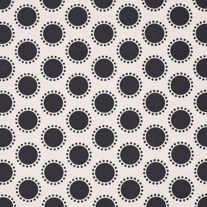 Light fabric with black circles outlined by small white dots in a repeating geometric dot pattern.