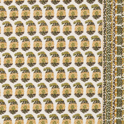 Cream fabric with repeating green-gold pineapple print and decorative border stripe; tropical textile for upholstery.