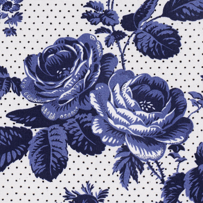 Blue rose floral print fabric with navy petals on white dotted background; vintage botanical pattern.