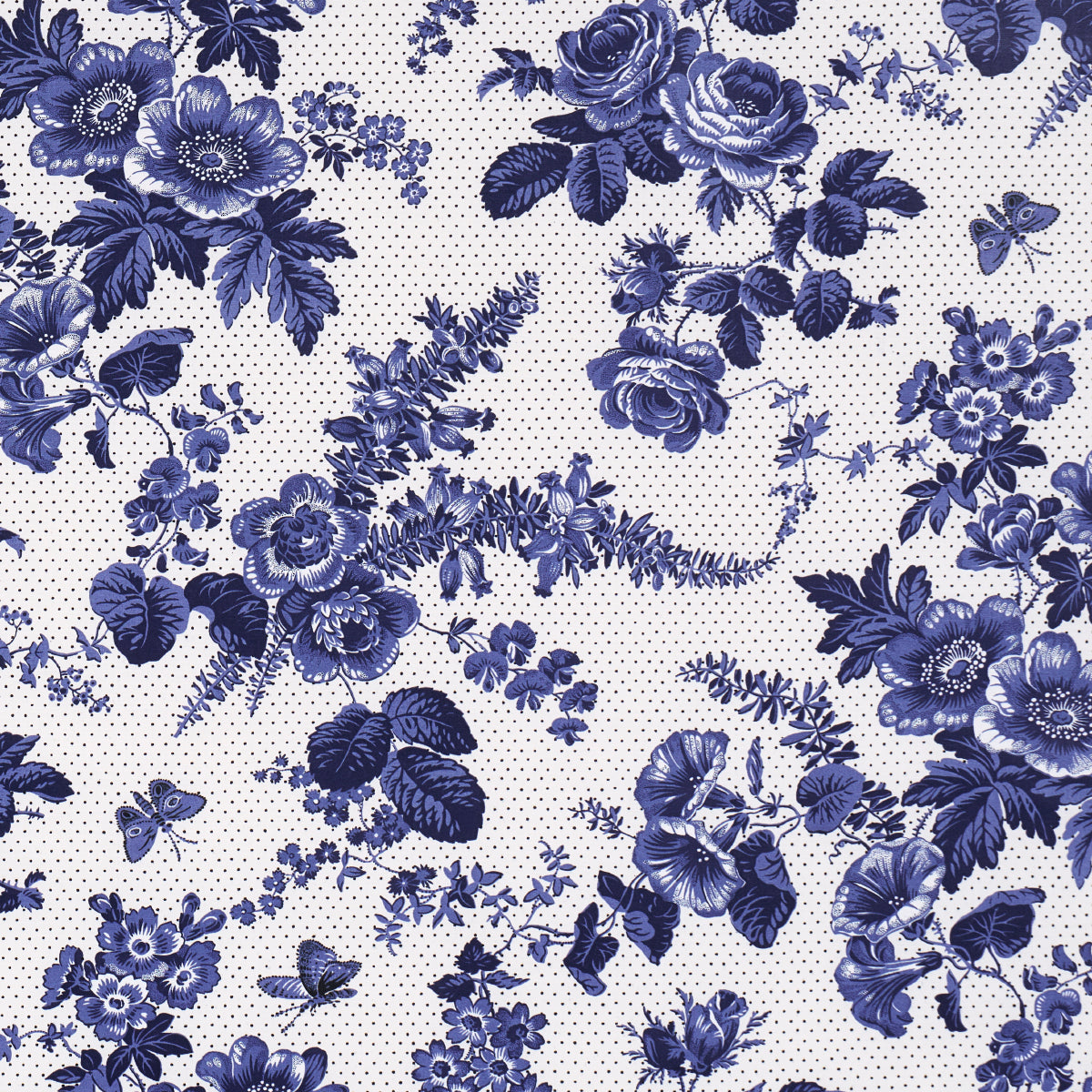 Indigo blue floral print fabric with roses and leaves on a pale dotted background; vintage botanical pattern.