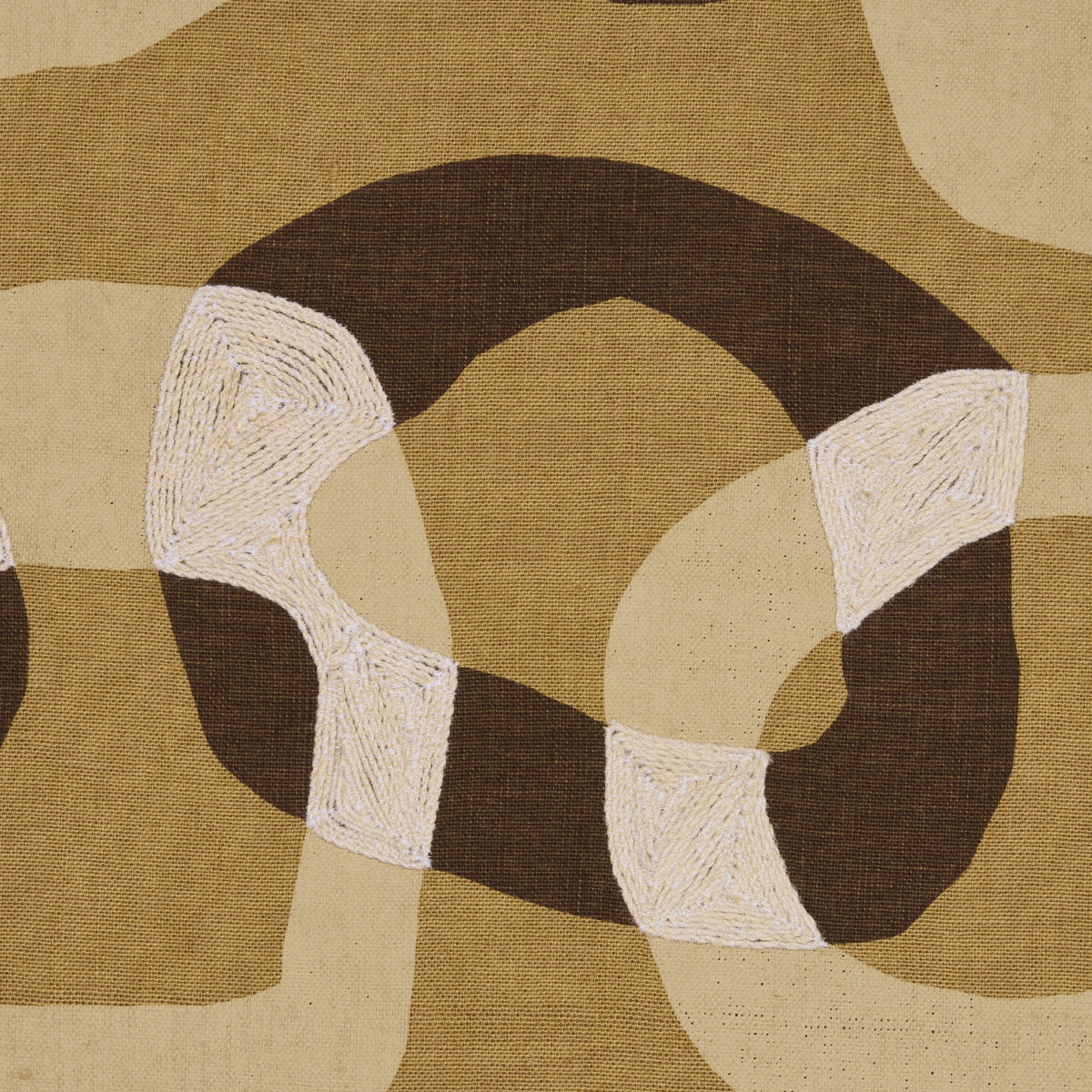 Abstract geometric rug in earthy beige, tan, & brown with white textured loops forming a circular knot.