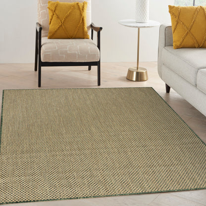 Beige woven area rug with green edge in a contemporary living room; mustard throw pillows on beige chair and gray sofa.