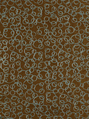 Brown textile with repeating light blue circular loop pattern; abstract geometric fabric suitable for upholstery or decor.
