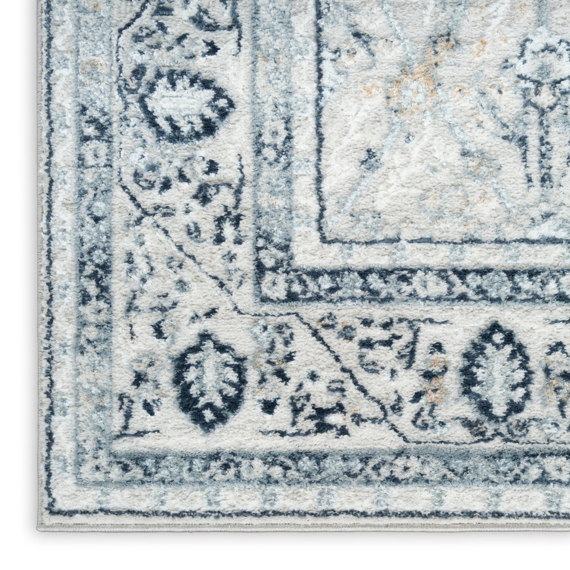 Rectangular blue-gray and ivory rug with ornate floral border, traditional style, soft plush pile.