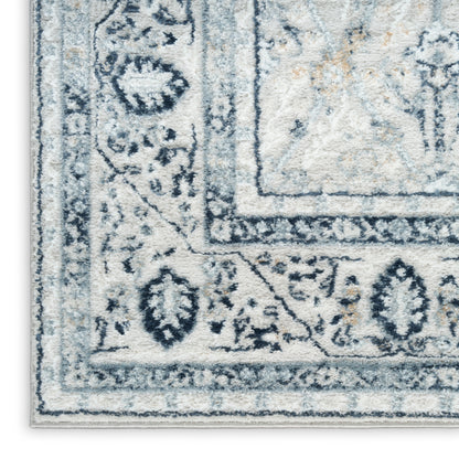Rectangular blue-gray and ivory rug with ornate floral border, traditional style, soft plush pile.