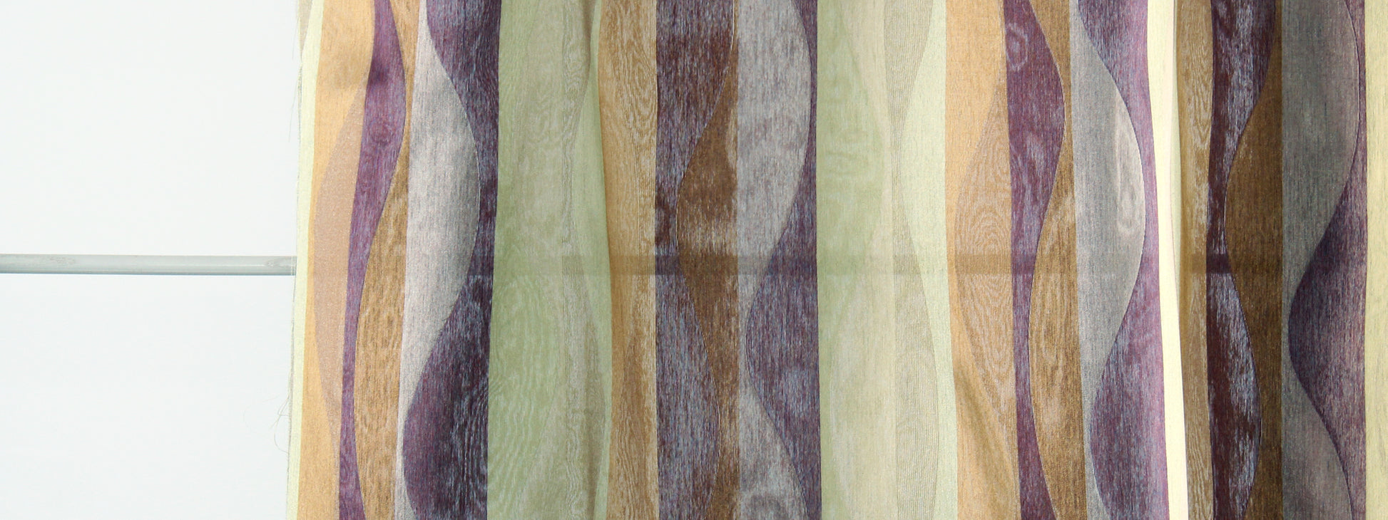 Colorful sheer curtain with wavy vertical stripes in purple, green, beige and brown.