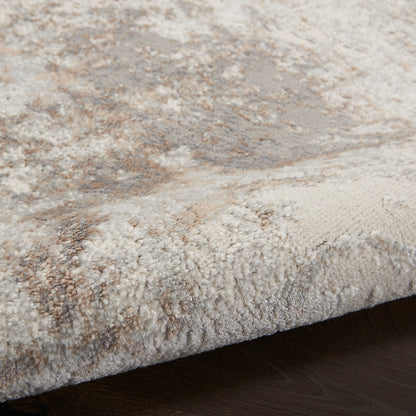 Soft plush beige and cream rug with taupe accents, thick pile and stitched edge for cozy living room decor.