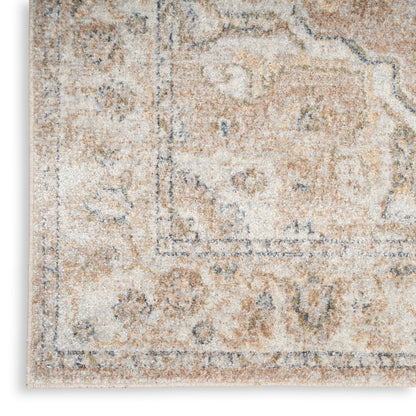 Distressed cream and beige area rug with muted blue-gray motifs; vintage Persian-inspired design, soft pile.