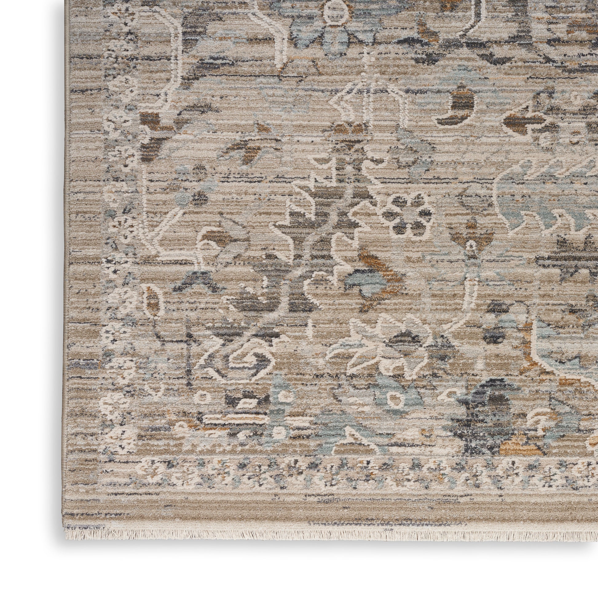 Rectangular beige, gray, and blue distressed floral area rug with fringed edges.