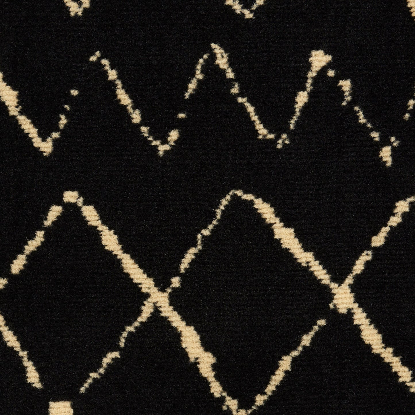 Black rug with cream diamond lattice zigzag pattern; soft woven textile for modern living spaces.