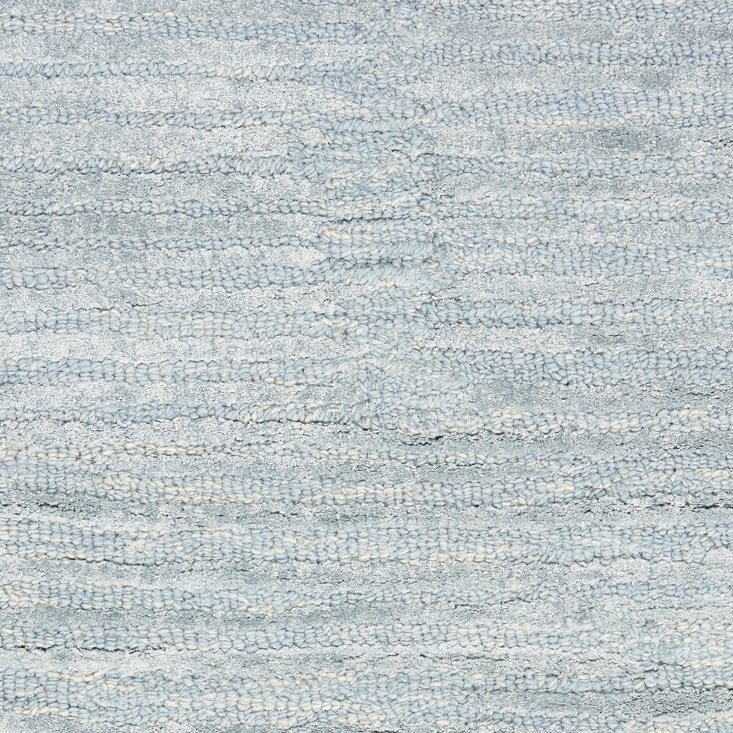 Light blue-gray terry cotton towel texture with looped fibers; soft bath towel.