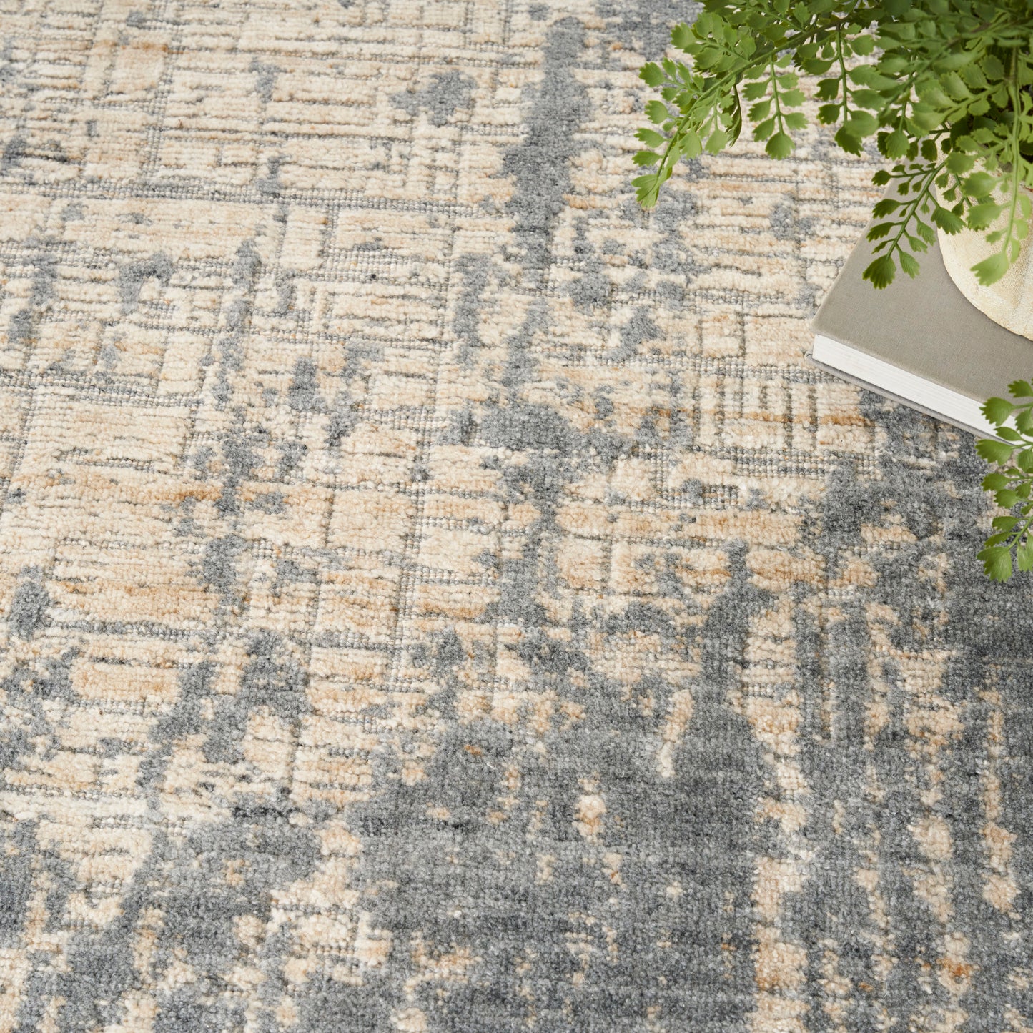 Abstract beige and blue-gray rug with distressed pattern; contemporary living room decor.