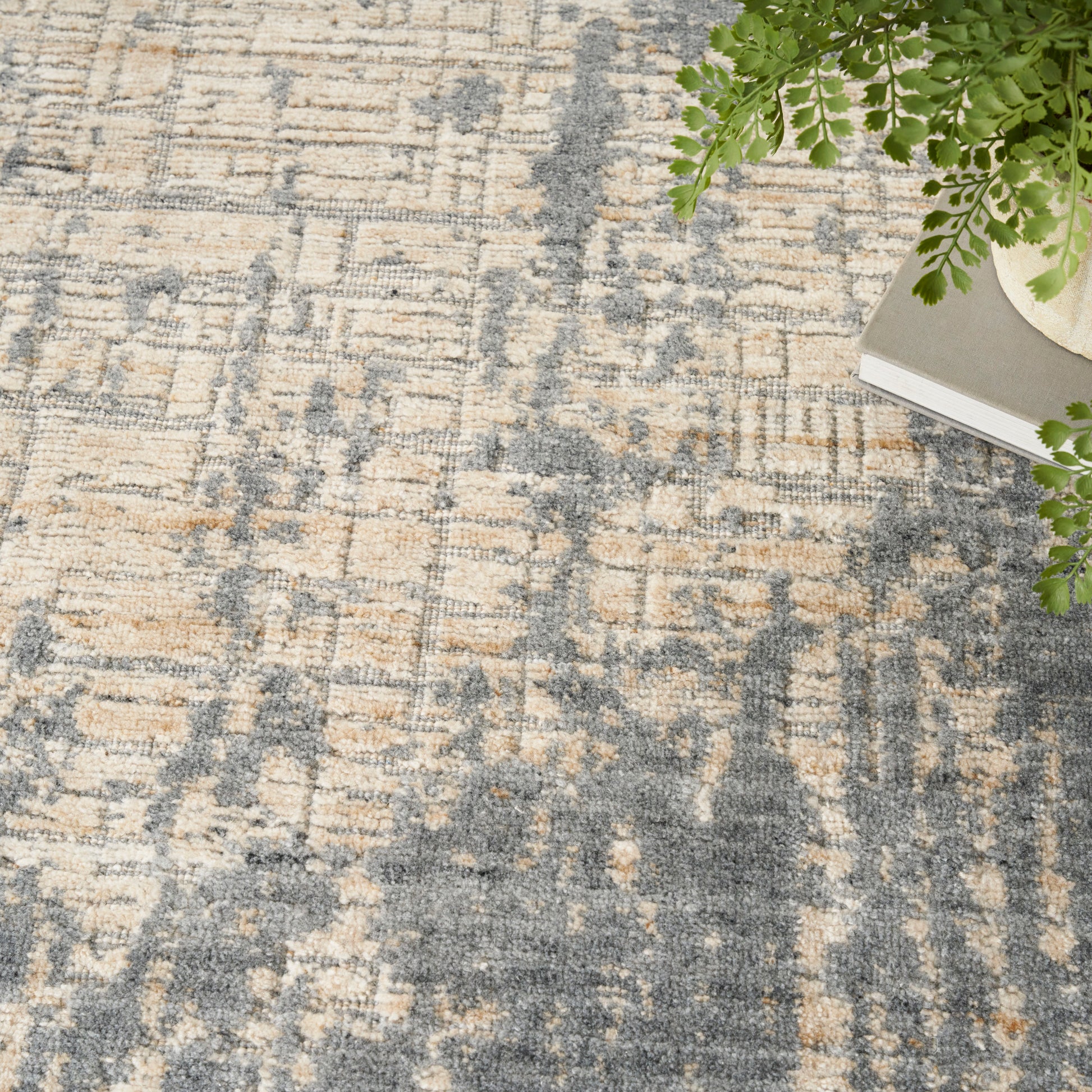 Abstract beige and blue-gray rug with distressed pattern; contemporary living room decor.