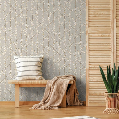 Beige wallpaper with a white botanical pattern; wooden bench with striped cushion, beige knit throw, and a potted snake plant.