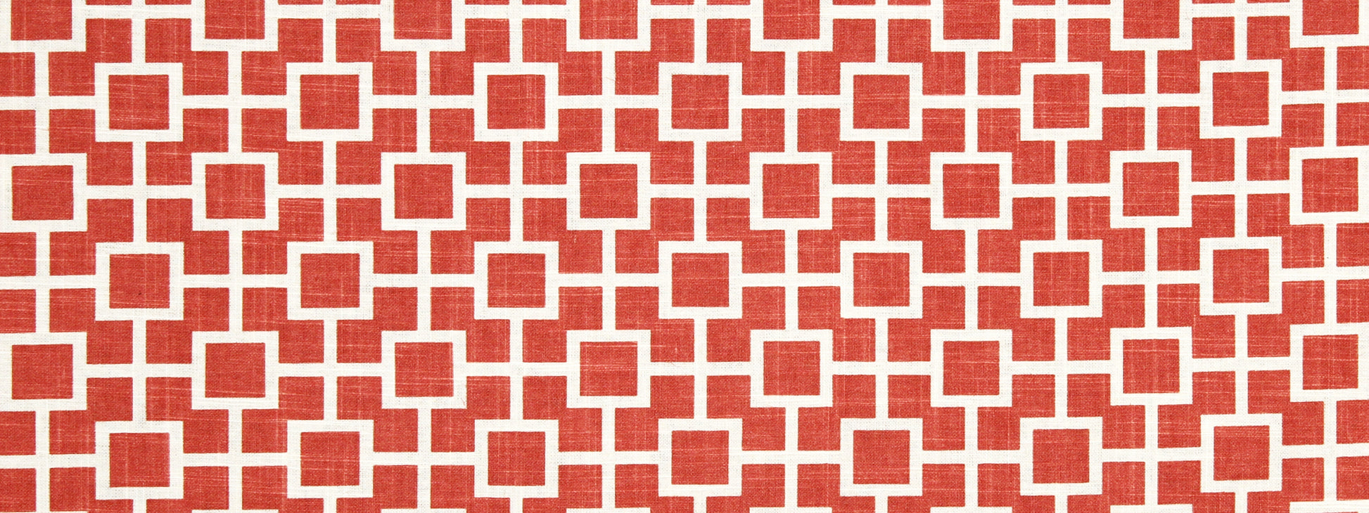 Red and white geometric grid drapery fabric with interlocking square motifs; woven texture, modern decorative textile.