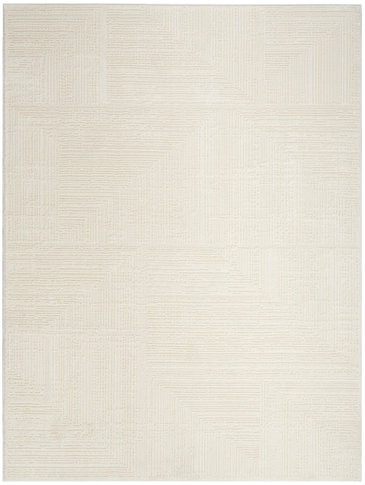 Cream rectangular area rug with geometric patchwork of raised linear textures; modern, neutral decor.
