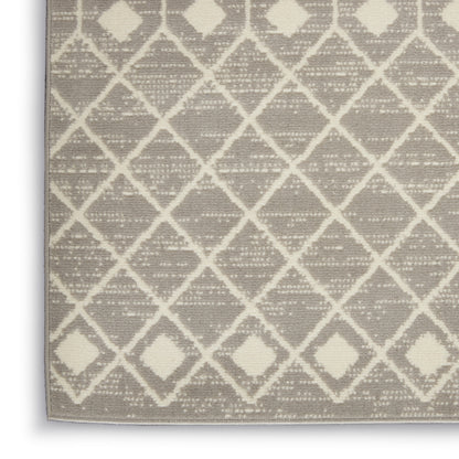 Rectangular rug with cream diamond lattice pattern on taupe background, textured woven surface.