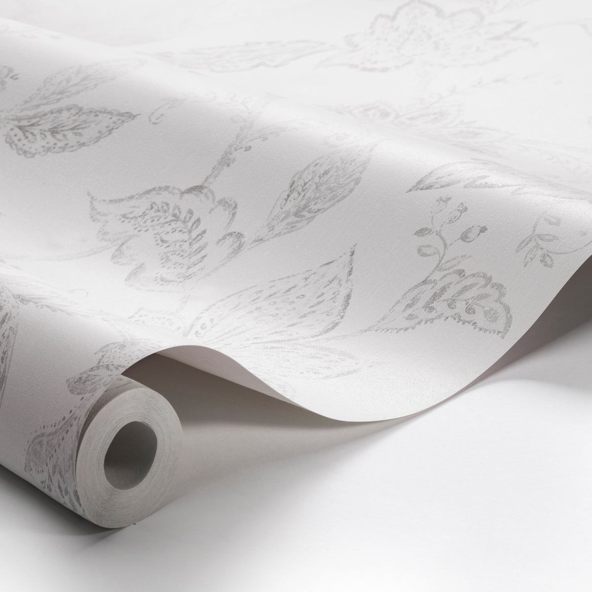 White wallpaper with a subtle gray floral pattern, rolled at the edge, decorative wall covering for interiors.