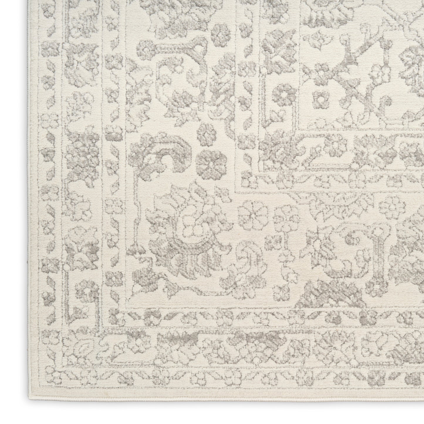 Cream area rug with a subtle light-gray floral border in a Persian-style pattern; rectangular decorative living room rug.