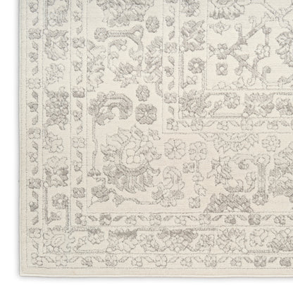 Cream area rug with a subtle light-gray floral border in a Persian-style pattern; rectangular decorative living room rug.
