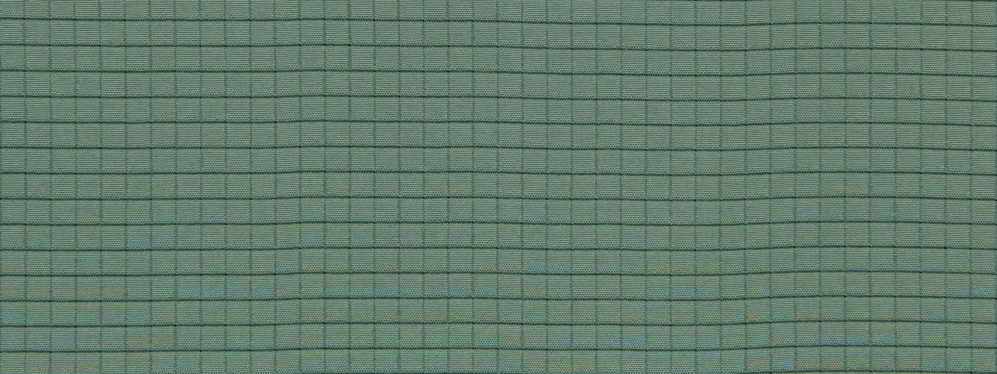 Close-up of green fabric with a fine dark teal grid pattern and subtle woven texture