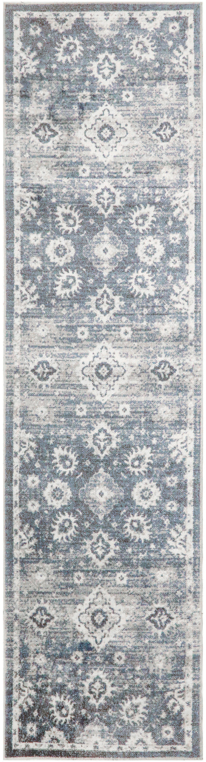 Blue-gray narrow runner rug with repeating diamond and floral medallions; distressed vintage look, ideal for hallways.