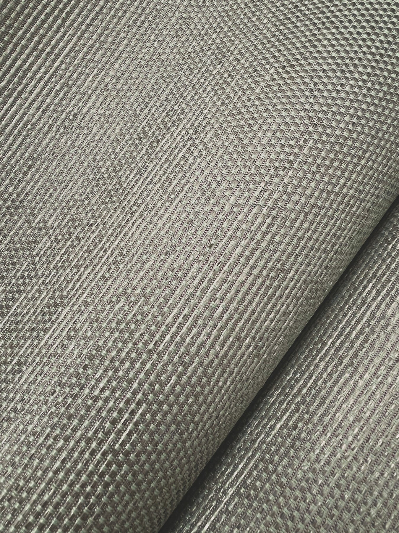 Argent dusty blue wallpaper with a subtle ribbed woven texture.