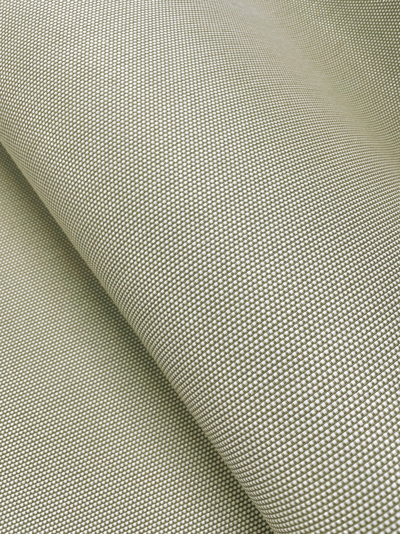 Beige woven wallpaper close-up with a tight grid texture and rolled edge.