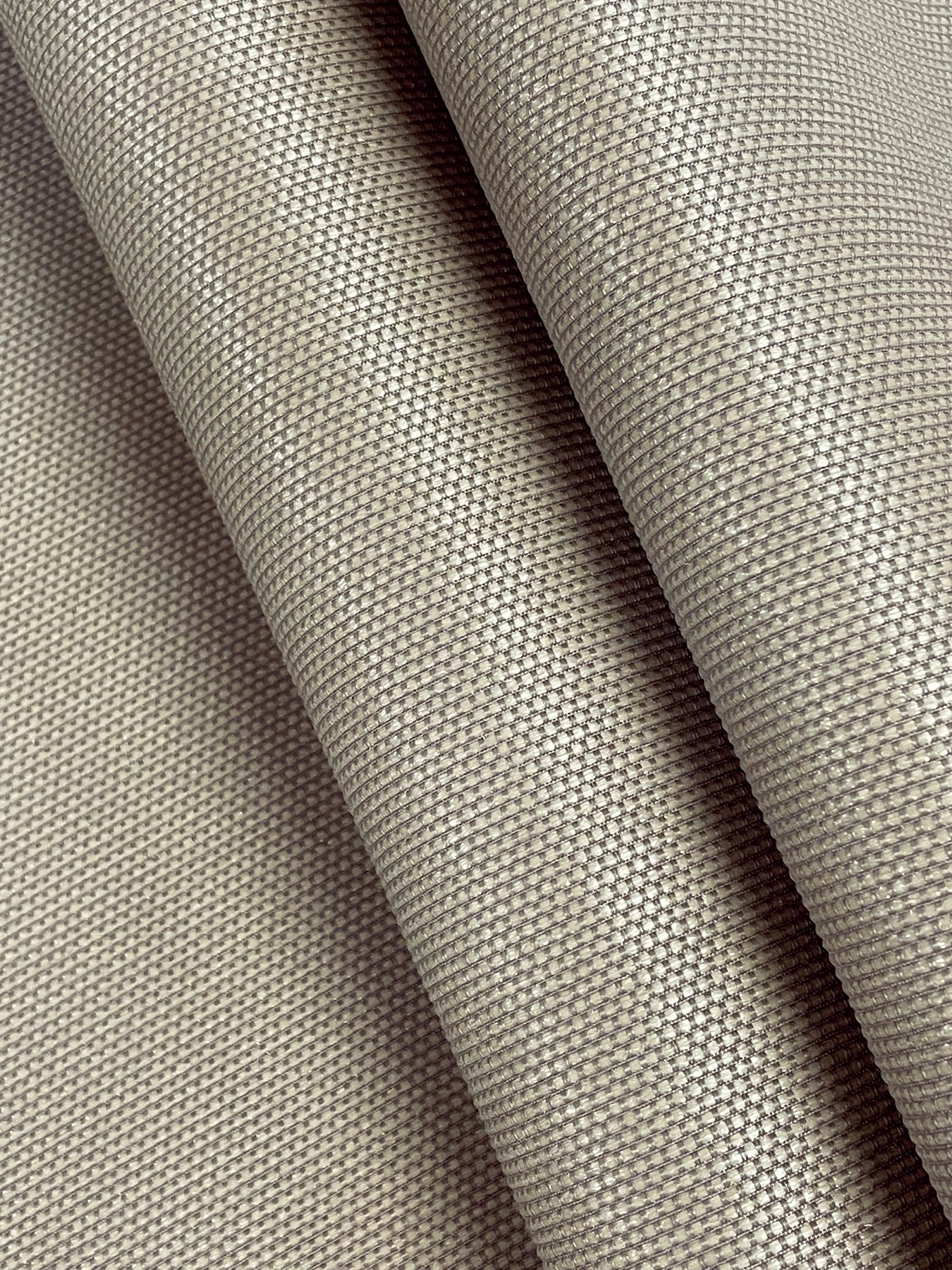 Beige woven wallcovering close-up with a tight grid weave; brown-toned, fabric-like texture.