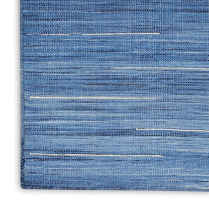 Blue denim-like woven rug with subtle beige horizontal streaks; rectangular, casual modern home decor.