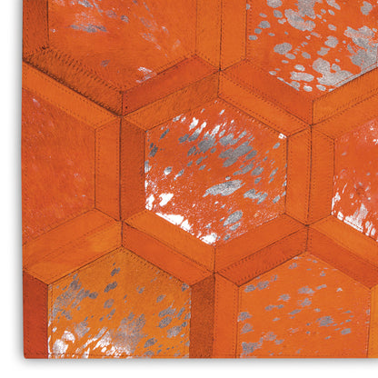 Close-up of orange hexagonal quilted leather pattern with stitched seams and silver speckles.