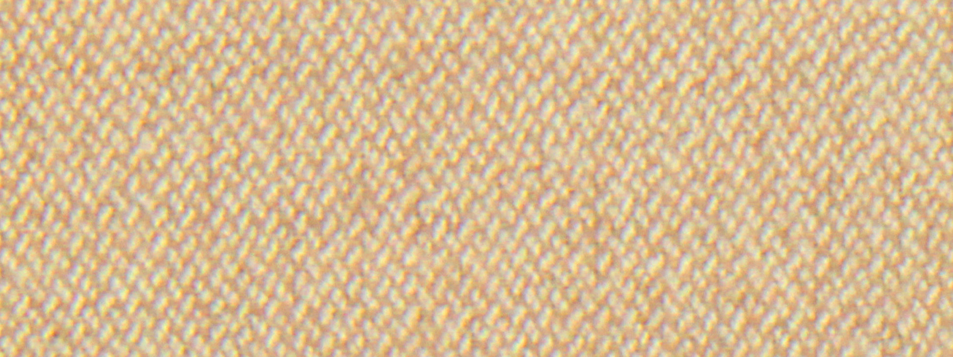Close-up of sand-colored wool flannel fabric with diagonal twill texture and cream threads; warm textile swatch.
