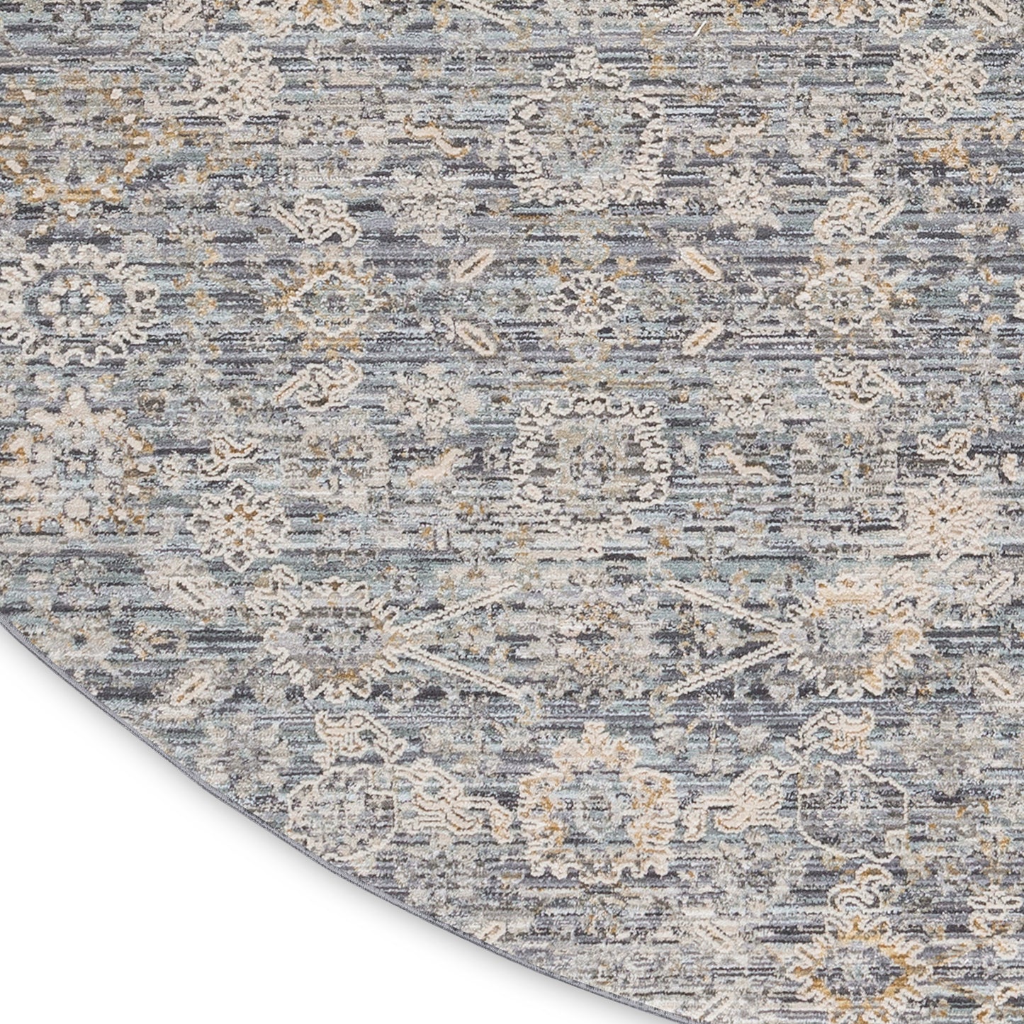 Round blue-gray rug with beige floral medallions and distressed pattern, soft textured.