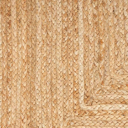 Natural jute rug with braided border, warm beige tones, and textured weave.