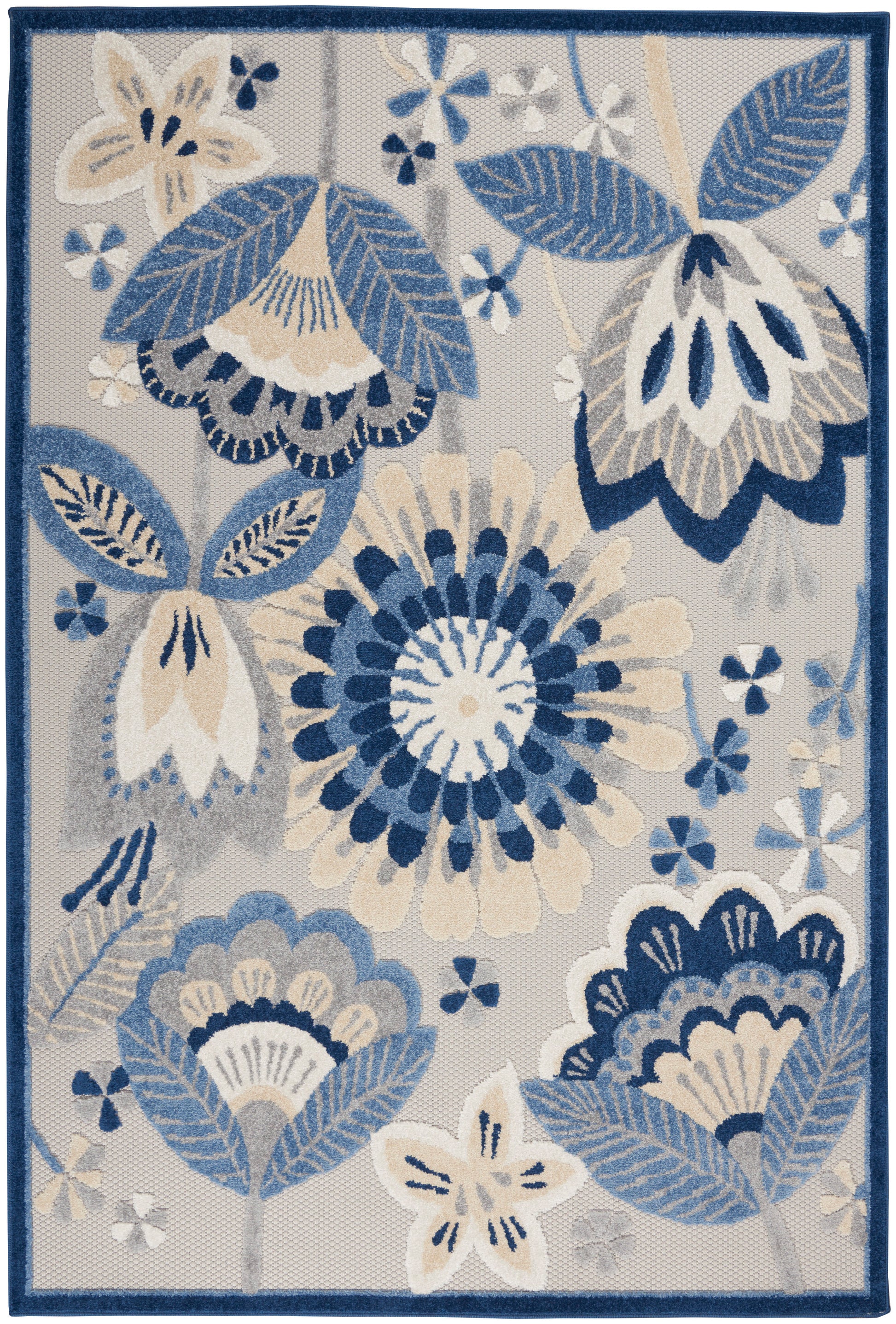 Rectangular area rug in blue, ivory and beige florals with a navy border; woven decorative home accent.