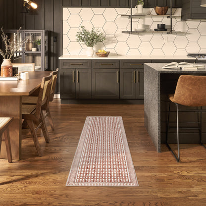 Dark contemporary kitchen with white hex tile backsplash, island, wooden dining table & chairs, brown runner rug