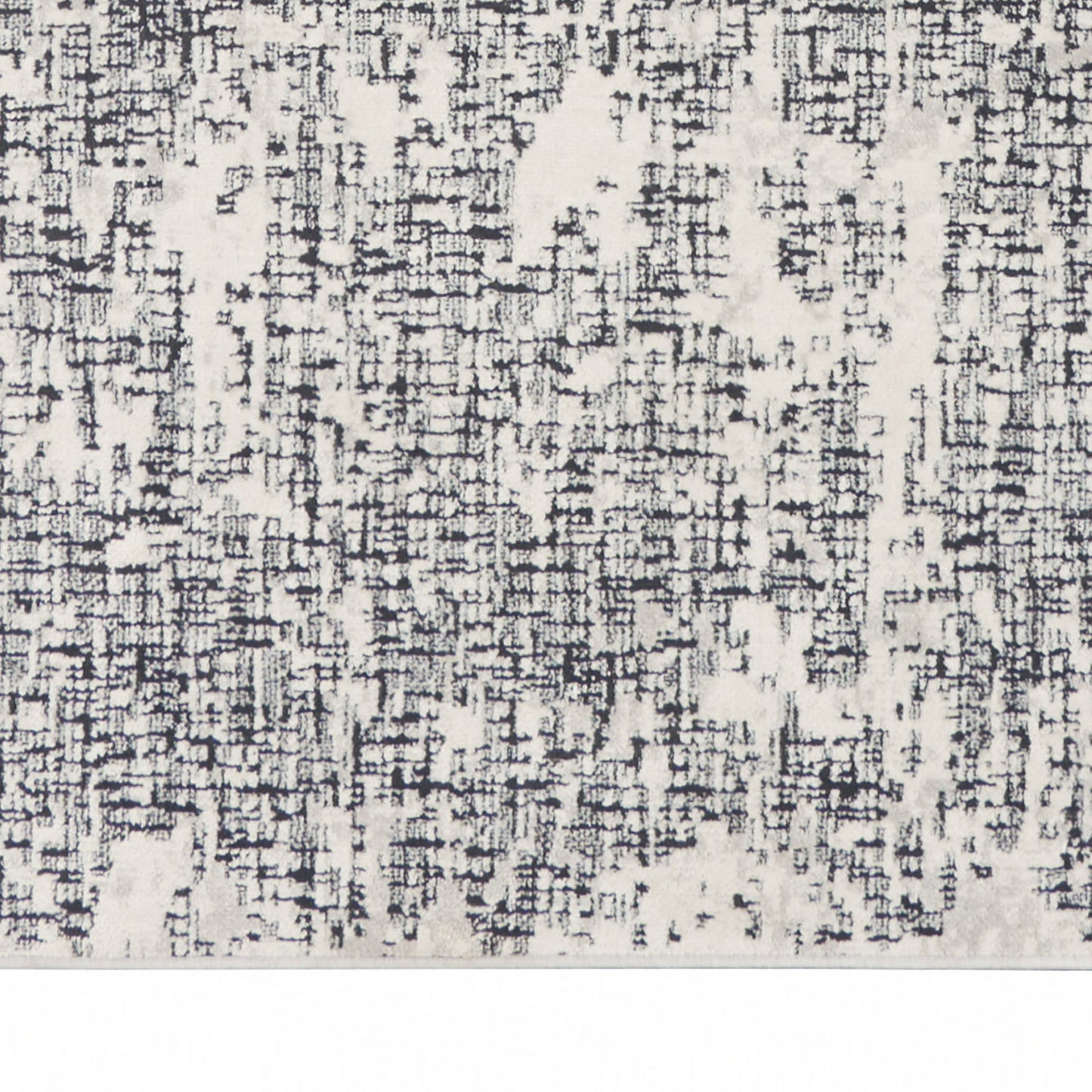 Ivory area rug with abstract black-gray distressed grid pattern, soft woven texture.