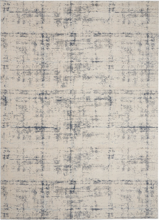 Beige distressed area rug with muted blue-gray abstract grid pattern and soft woven texture.