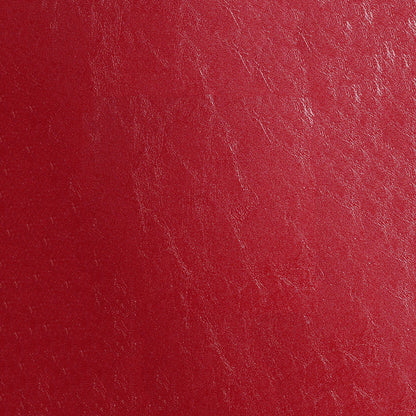 Close-up of red distressed fabric texture with natural grain.