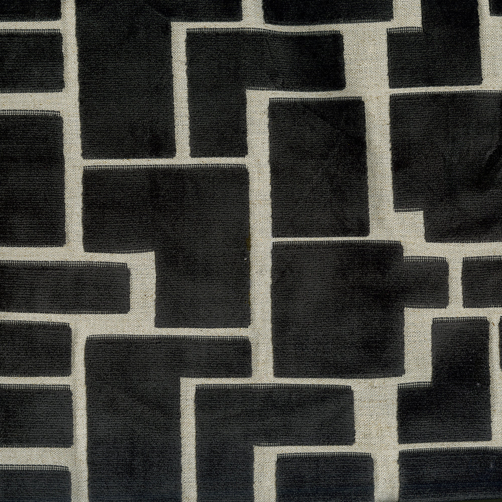 Geometric black rectangular blocks on a neutral beige fabric background; modern interlocking maze pattern.
