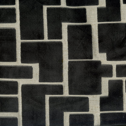 Geometric black rectangular blocks on a neutral beige fabric background; modern interlocking maze pattern.