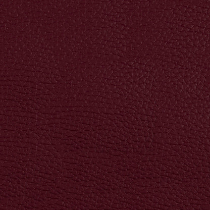 Close-up of burgundy pebbled fabric texture with rich wine red hue.