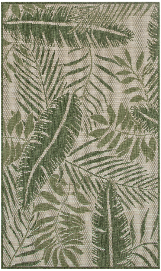 Green fern leaf pattern on beige outdoor woven rug; botanical decor.
