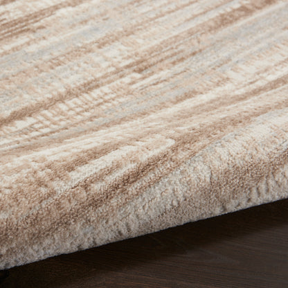 Beige plush runner rug with a soft abstract pattern, resting on a dark wood floor.